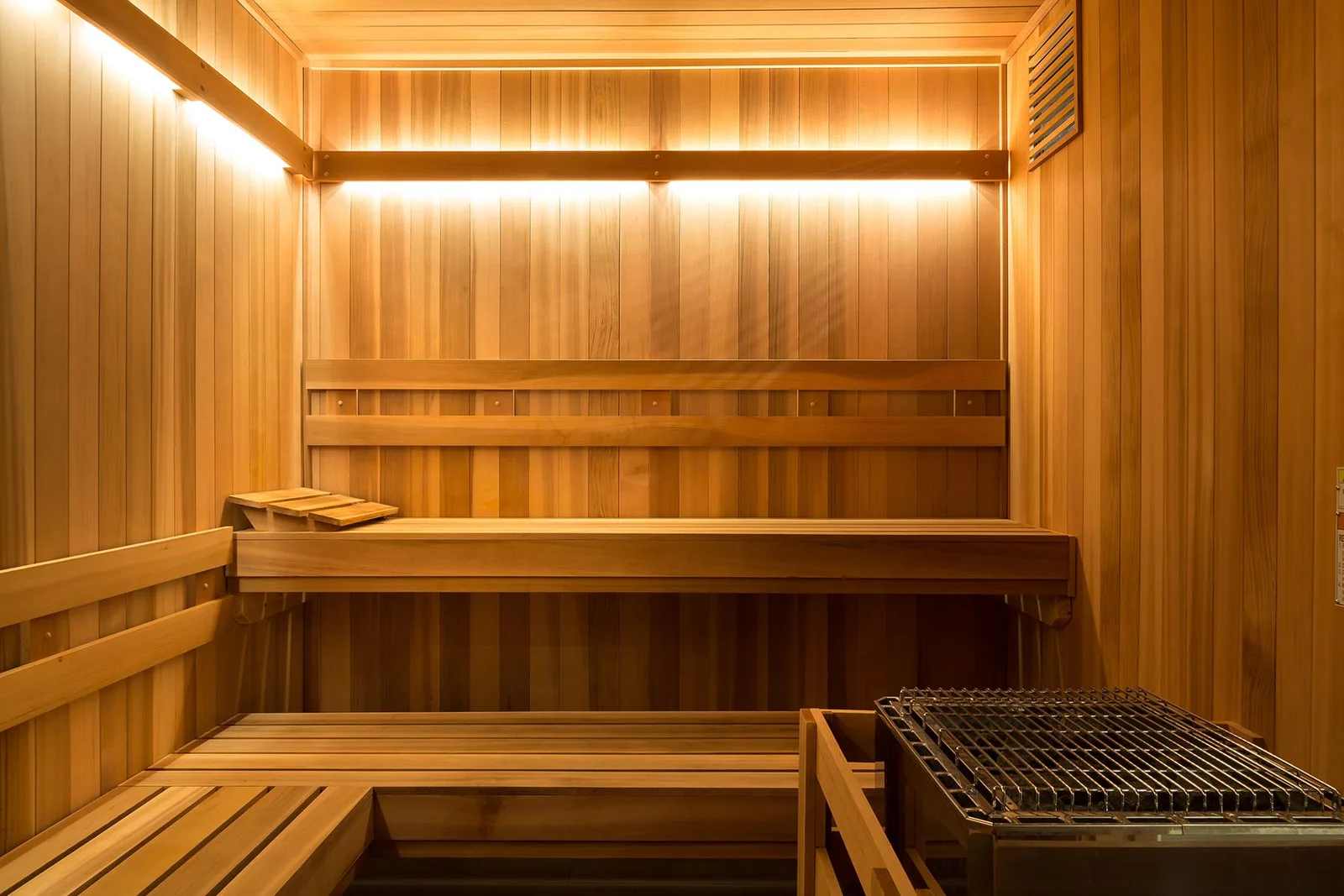 Hollycrest: A generous commercial sauna for an upscale apartment community, featuring a floor-standing lava-rock heater.