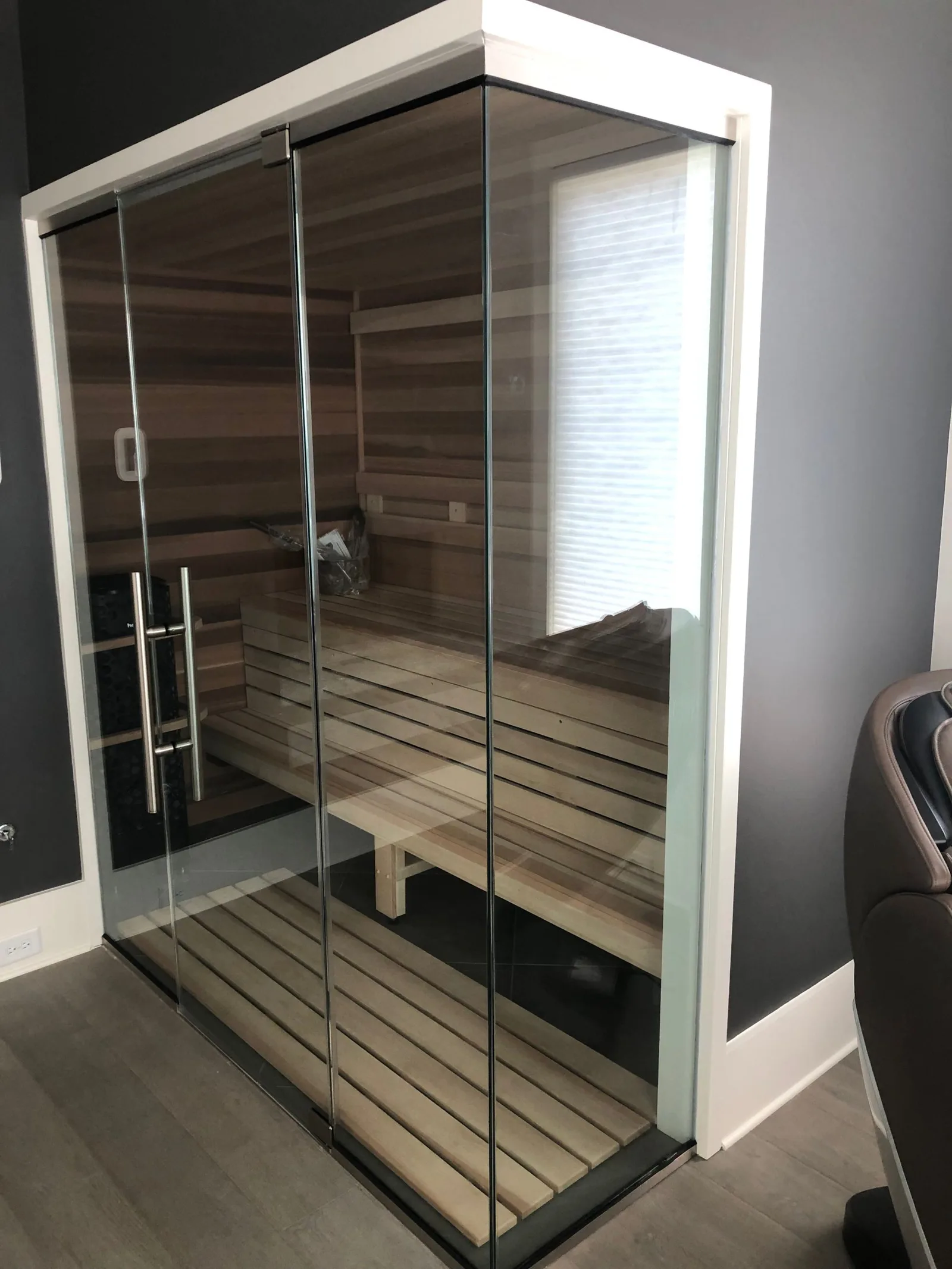 Norman: Glass across the front and right-hand walls opens up the room, with a Pikkutonttu heater and valance LED lighting.